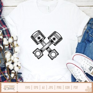 May include: White t-shirt featuring a black and white graphic of two crossed engine pistons. The shirt is made of a soft material. The bottom of the shirt shows the text "VECTORS by Sarmad" and file type options.