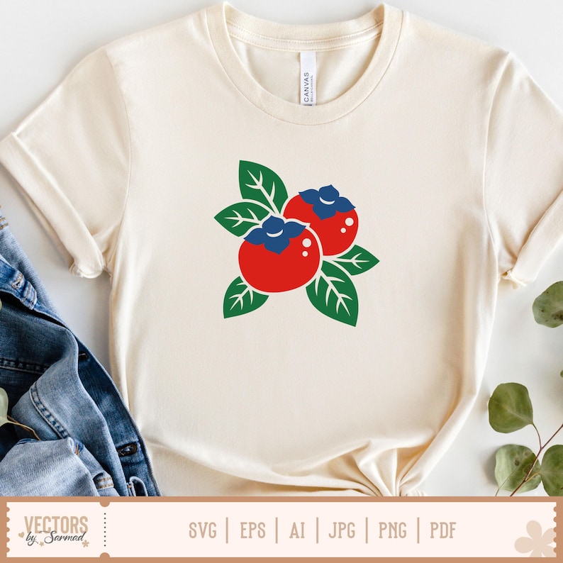 May include: Cream-colored t-shirt featuring a graphic of two red berries with blue tops and green leaves. The shirt has short sleeves and a round neckline. The bottom of the shirt displays the text "VECTORS by Sarmad" and file type options.