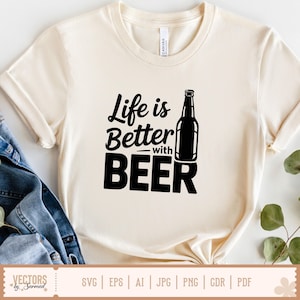 May include: Cream-colored t-shirt with the phrase "Life is Better with BEER" in black lettering. A black beer bottle graphic is to the right of the text. The shirt has short sleeves and a crew neck.
