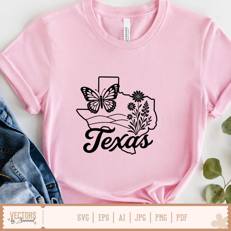 May include: Pink t-shirt with a black graphic of the state of Texas, a butterfly, and floral elements. The word "Texas" is written in a cursive font below the graphic. The shirt is made of a soft material.