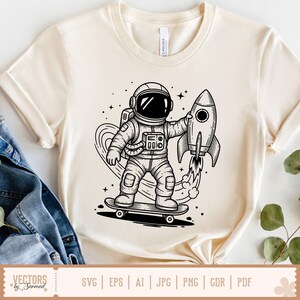 May include: Cream-colored t-shirt featuring a black and white illustration of an astronaut on a skateboard holding a rocket. The design includes stars and a heart-shaped trail. The shirt has short sleeves and a crew neck. The bottom of the shirt has the text "VECTORS by Sarmad" and file type options.