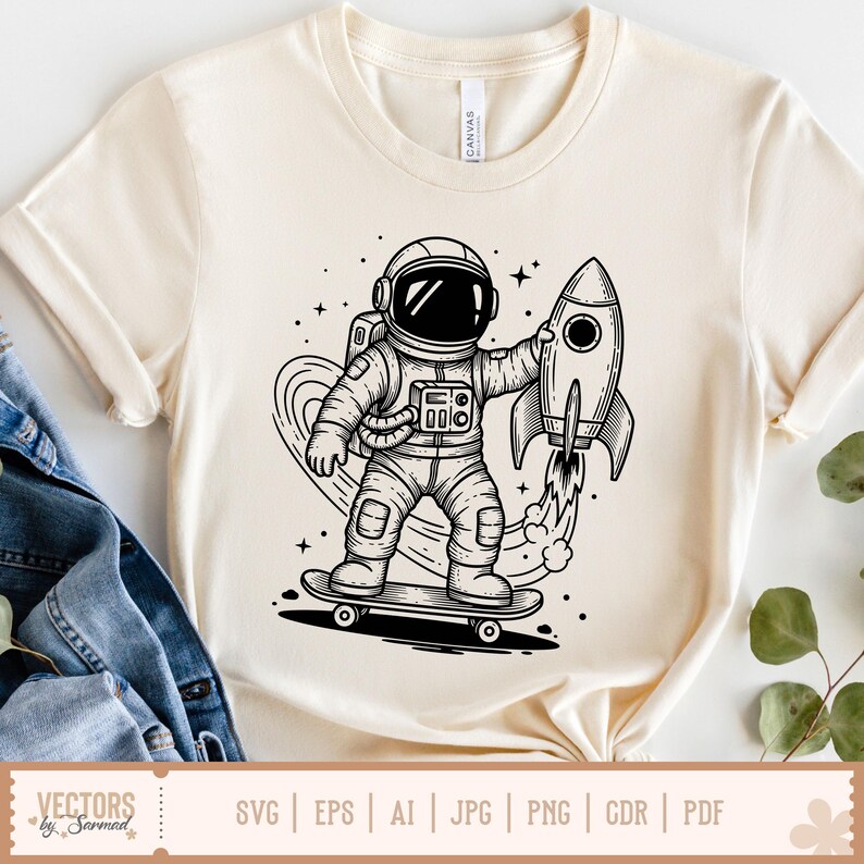 May include: Cream-colored t-shirt featuring a black and white illustration of an astronaut on a skateboard holding a rocket. The design includes stars and a heart-shaped trail. The shirt has short sleeves and a crew neck. The bottom of the shirt has the text "VECTORS by Sarmad" and file type options.