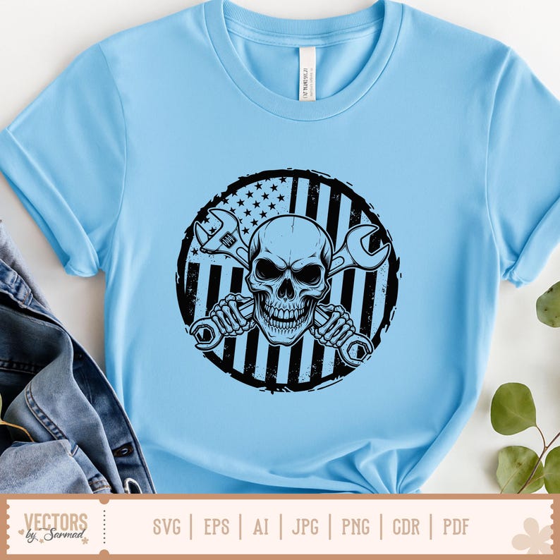 May include: Light blue t-shirt featuring a black and white graphic of a skull holding two wrenches, set against a circular American flag design. The shirt is a crew neck and has short sleeves. The bottom of the shirt has the text "SVG | EPS | AI | JPG | PNG | CDR | PDF".