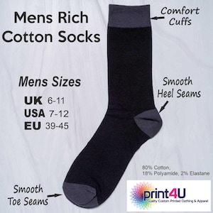 May include: Black and gray men's cotton socks with "Comfort Cuffs" and "Smooth Heel Seams." The socks are available in sizes UK 6-11, USA 7-12, and EU 39-45. The socks are made of 80% cotton, 18% polyamide, and 2% elastane.