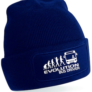 May include: A navy blue knitted beanie with a white patch featuring a stick figure evolution sequence ending with a bus driver. The patch reads "Evolution Bus Driver".