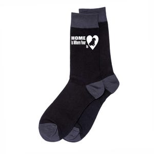 May include: Black and gray socks with a white heart and a dog silhouette. The socks have the text "Home is Where Your Is" on them.