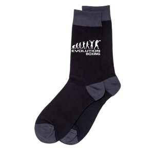 May include: Black and gray crew socks with a white graphic of a boxing evolution silhouette and the text "Evolution Boxing".