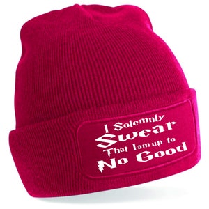 May include: A pink knit beanie with a white patch that reads "I Solemnly Swear That I Am Up To No Good".