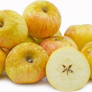 May include: A collection of golden-yellow apples with red blush, some whole and one sliced in half, revealing the star-shaped core. The apples are ripe and fresh, perfect for a healthy snack or baking.