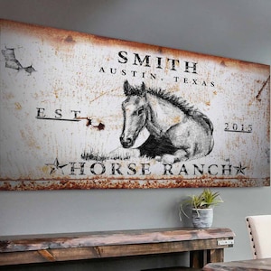 May include: Rustic metal sign with a white background and brown rust accents. The sign features a black and white drawing of a horse, the text "SMITH AUSTIN, TEXAS EST. 2015 HORSE RANCH", and a star.