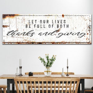 May include: Rustic white metal sign with a distressed, rusty look. The sign reads "Let our lives be full of both thanks and giving".
