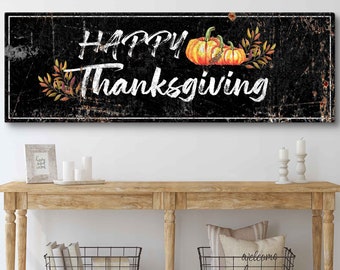 May include: Black and white sign with the text "Happy Thanksgiving" in white script font. The sign has a distressed look and features a watercolor illustration of three orange pumpkins with green leaves.