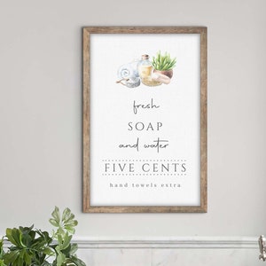 May include: A watercolor illustration of a bathroom sign with the text "fresh SOAP and water FIVE CENTS hand towels extra". The illustration includes a bottle of soap, a towel, a plant, and a bar of soap.