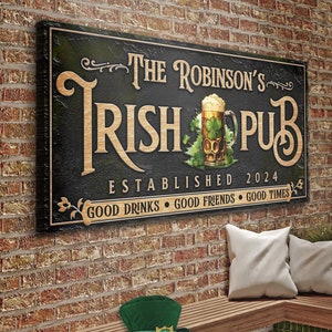 May include: A black and green sign with the text "The Robinson's Irish Pub Established 2024 Good Drinks Good Friends Good Times" and a graphic of a glass of beer with shamrocks.
