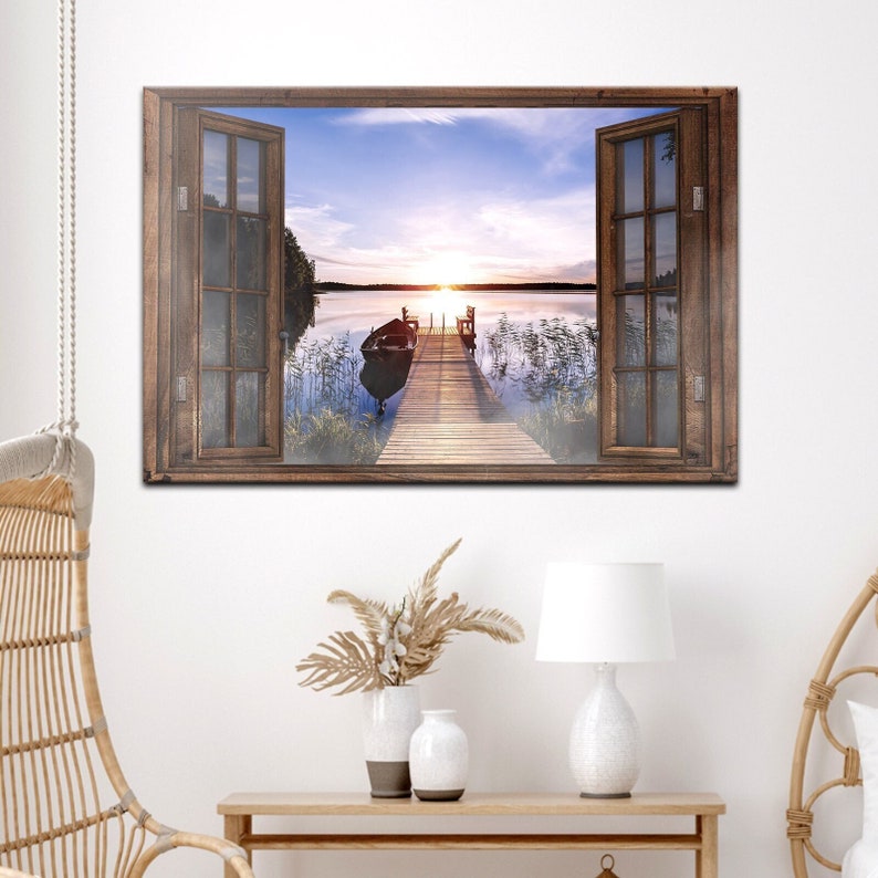 May include: A wooden window frame with an open window view of a lake with a wooden jetty and a small boat. The sun is setting over the lake, creating a warm glow in the sky.