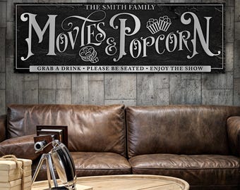 May include: Black and white sign with the text "Movies & Popcorn" and the words "The Smith Family" above. The sign also says "Grab a drink, Please be seated, Enjoy the show".