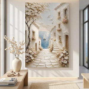 May include: A textured oil painting on canvas depicting a Mediterranean coastal scene with white stone buildings, a cobblestone path leading to a blue sea, a sailboat, and blooming flowers. The artwork features thick impasto brushstrokes.