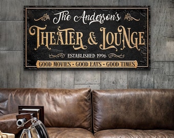 May include: Black and gold sign with the text "The Anderson's Theater & Lounge Established 1996 Good Movies - Good Eats - Good Times"