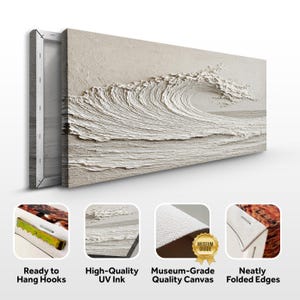 May include: A textured canvas print depicting a breaking wave in shades of white and beige. The artwork features a three-dimensional effect, with visible brushstrokes creating a sense of movement. The canvas is stretched on a wooden frame, ready to hang.