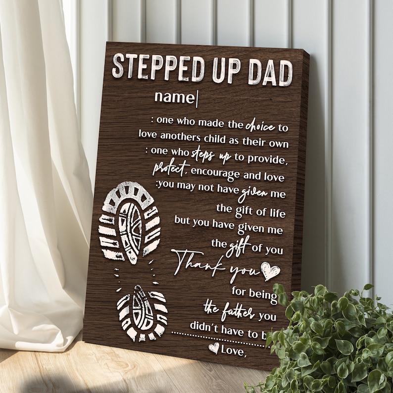 May include: A brown wooden sign with white text that reads "Stepped Up Dad" and a heartfelt message about the love and support a stepdad provides. The sign features a footprint design.