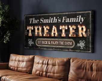 May include: A black and white sign with the text "The Smith's Family Theater" in a vintage marquee style with light bulbs. The sign also says "Sit back & enjoy the show" and has two film cameras on either side of the text.