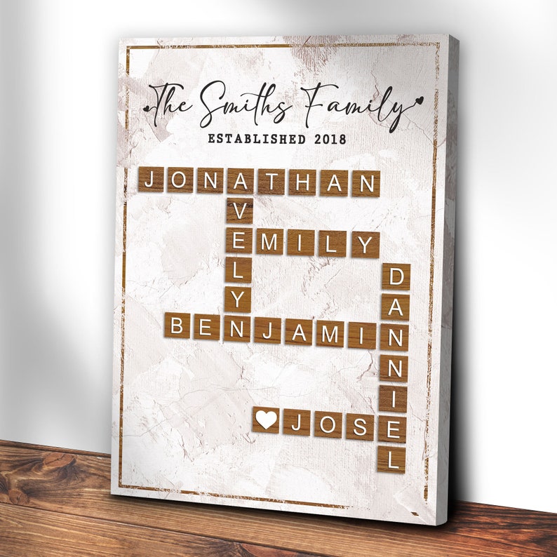 May include: A white canvas print with a brown woodgrain background. The text "The Smiths Family Established 2018" is at the top. The names Jonathan, Emily, Benjamin, and Jose are spelled out in a crossword puzzle style using wooden letter tiles.