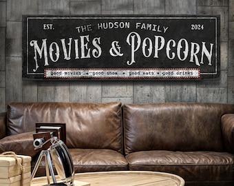 May include: Black and white sign with the text "EST. THE HUDSON FAMILY 2024 MOVIES & POPCORN good movies good show good eats good drinks".