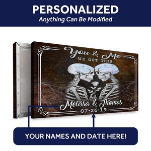 May include: A personalized canvas print with a dark wood background and a couple of skeletons holding a rose. The text reads "You & Me We Got This" and includes space for names and a date.