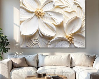 May include: A large, cream-colored floral canvas art piece. The artwork features two large, textured flowers with golden centers, set against a swirling, cream-colored background. The piece is displayed above a white sofa in a living room setting.