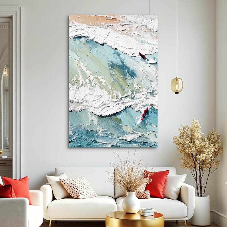 May include: Abstract oil painting of ocean waves in shades of blue, white, and beige. Two red surfboards are visible in the waves. The artwork is displayed above a white sofa with red pillows.