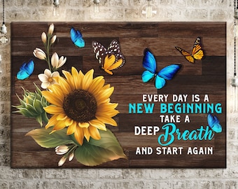 May include: A wooden sign with a sunflower, butterflies, and the text "Every day is a new beginning. Take a deep breath and start again."