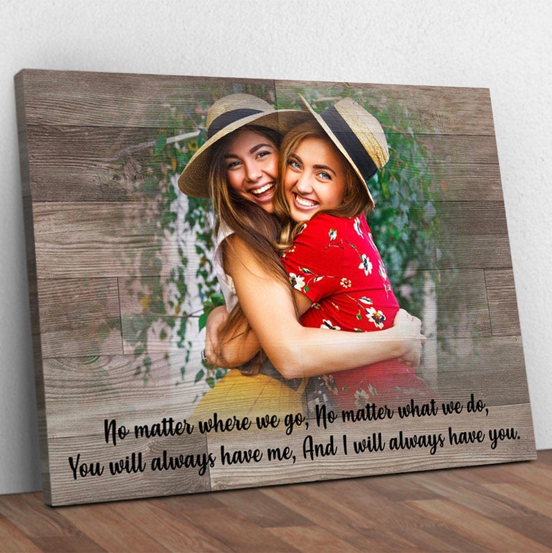 May include: Two women wearing straw hats are hugging each other. The image has a woodgrain background with the text "No matter where we go, No matter what we do, You will always have me, And I will always have you."