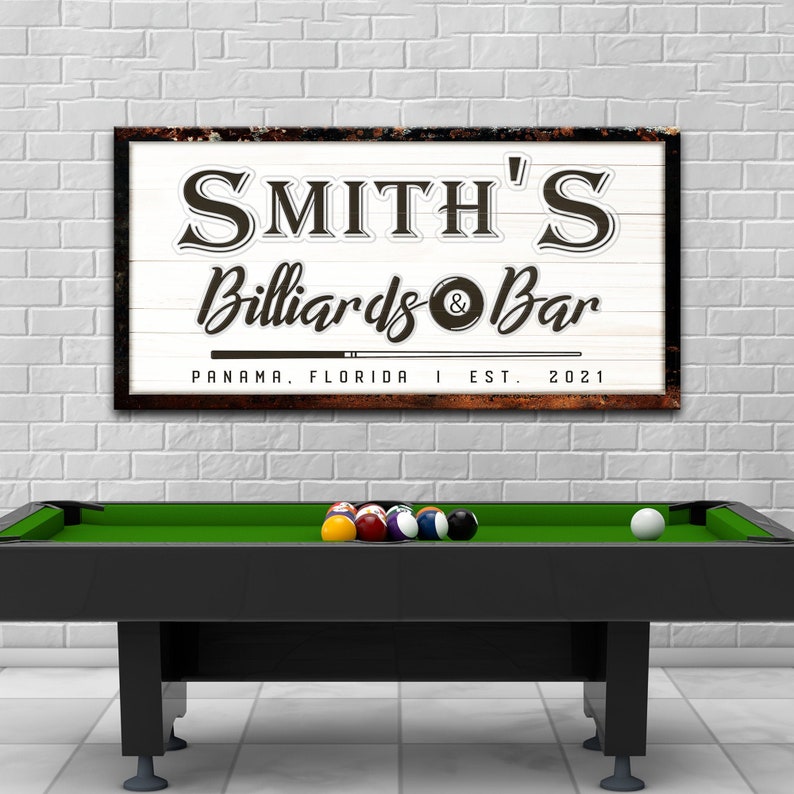 Billiard and Bar sign of custom established date and personalized billiard name text with cue stick and ball icons on a rustic white-wood-inspired canvas wall décor.