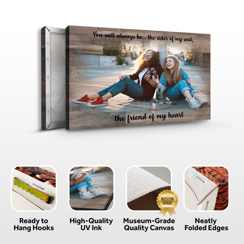 May include: Canvas print with a woodgrain background featuring a photo of two friends sitting on a sidewalk. The text "You will always be... the sister of my soul, the friend of my heart" is printed on the canvas. The print has ready-to-hang hooks and neatly folded edges.