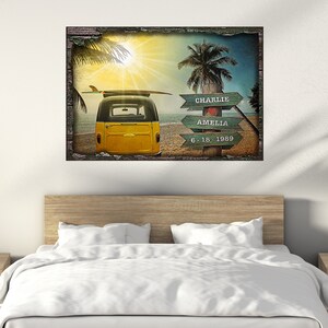 May include: A yellow vintage van with a surfboard on top parked on a beach with palm trees and a sign that reads "Charlie Amelia 6.18.1989".