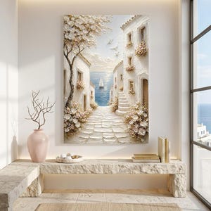 May include: A vertical textured oil painting depicting a Mediterranean coastal scene with white stone buildings, a cobblestone path, blooming flowers, and a sailboat on the blue sea. The artwork features thick impasto brushstrokes, a large tree with white blossoms, and white birds flying in the sky.