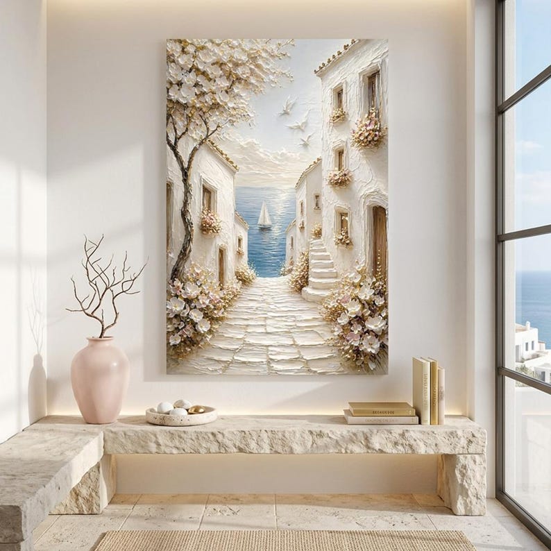 May include: A vertical textured oil painting depicting a Mediterranean coastal scene with white stone buildings, a cobblestone path, blooming flowers, and a sailboat on the blue sea. The artwork features thick impasto brushstrokes, a large tree with white blossoms, and white birds flying in the sky.