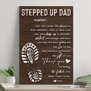 May include: A wood-grain background with white text that reads "Stepped Up Dad" and "name". The text continues with a message about a person who has stepped up to be a father. The message includes the words "protect, encourage, and love". The image also includes a series of white footprints.