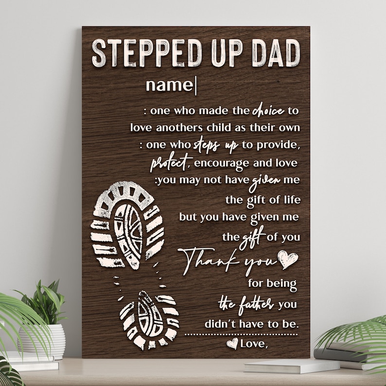May include: A wood-grain background with white text that reads "Stepped Up Dad" and "name". The text continues with a message about a person who has stepped up to be a father. The message includes the words "protect, encourage, and love". The image also includes a series of white footprints.