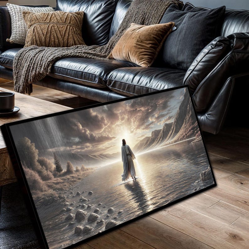 May include: A painting of a person walking on water towards a bright light in the distance. The person is wearing a long white robe and is surrounded by a cloudy sky and a body of water. The painting is framed in black.