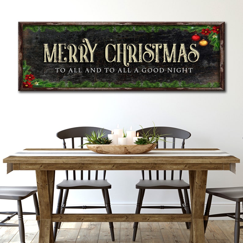 May include: A rustic wooden sign with a black background and green garland. The sign reads "Merry Christmas to all and to all a good night".