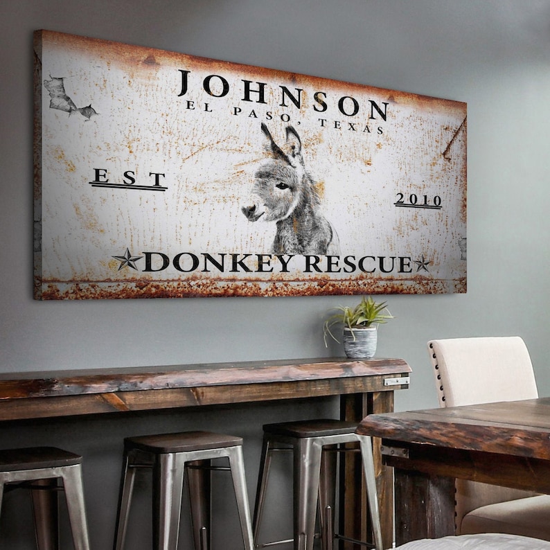 May include: Rustic metal sign with a donkey illustration and the text "JOHNSON EL PASO, TEXAS EST 2010 DONKEY RESCUE".