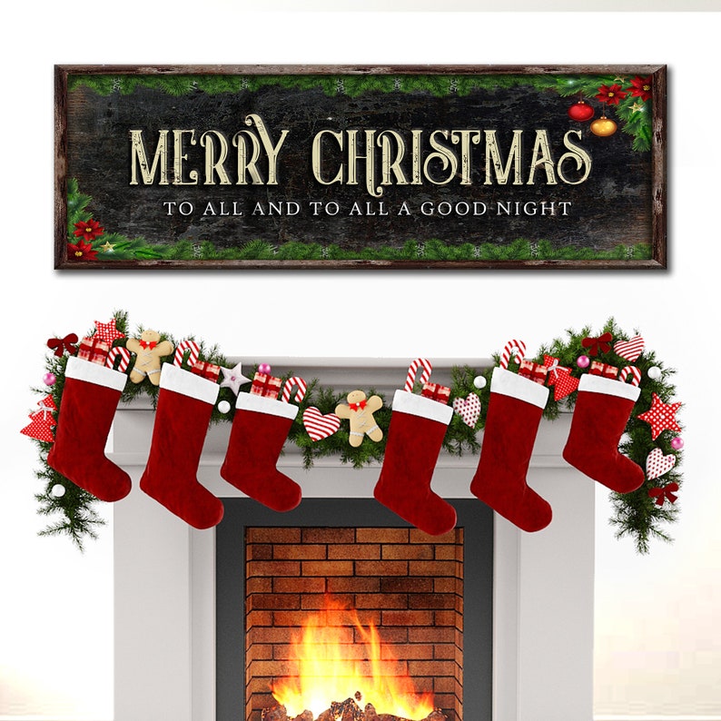 May include: A black chalkboard sign with the text "Merry Christmas to all and to all a good night" surrounded by a green garland. A fireplace with a fire burning in it is decorated with a garland of greenery and red stockings.