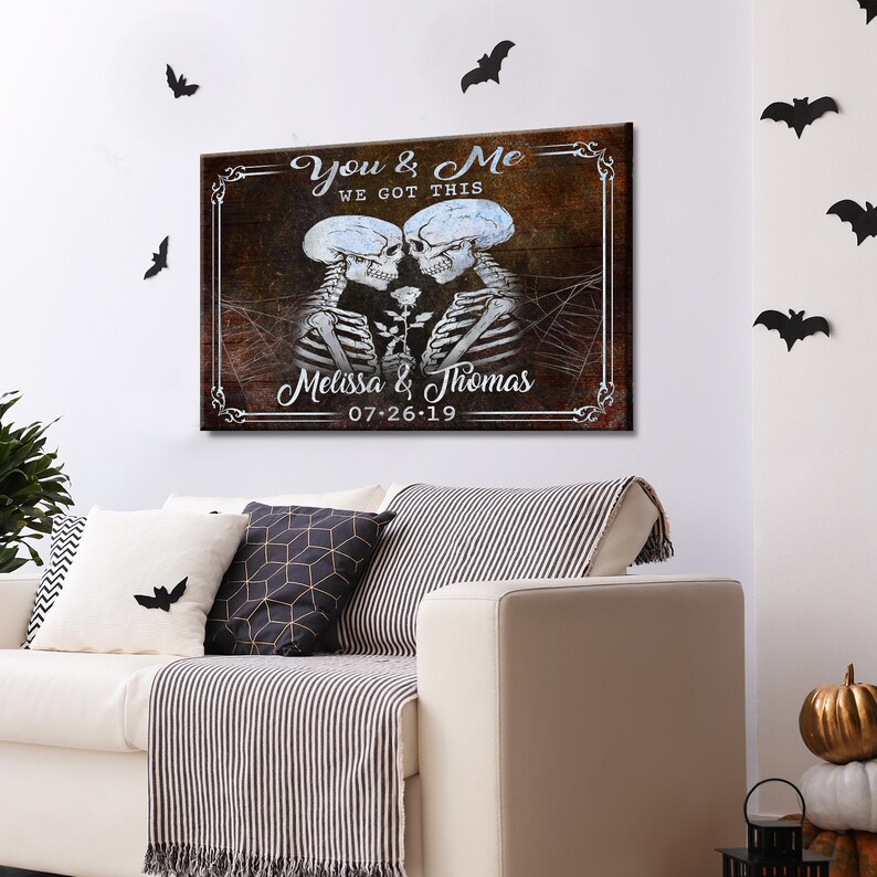 May include: A rustic wooden sign with a couple of skeletons holding a rose. The sign reads "You & Me We Got This Melissa & Thomas 07-26-19".