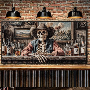 May include: A framed artwork depicting a skeleton wearing a cowboy hat and denim jacket, leaning on a bar. The bar is lined with bottles and glasses, with paintings on the wall. The background is a brick wall, and there are three black pendant lights.