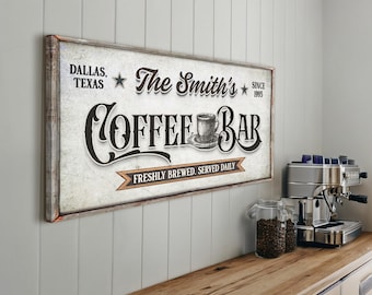 May include: A white sign with brown text that reads "The Smith's Coffee Bar" with a coffee cup illustration and the text "Dallas, Texas" and "Since 1993". The sign also has a brown ribbon with the text "Freshly Brewed, Served Daily".