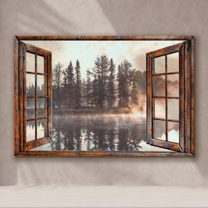 May include: A framed wall art piece depicting a serene forest scene viewed through an open window. The artwork features a misty lake reflecting the trees, with a warm sunrise glow. The window frame is made of dark wood.