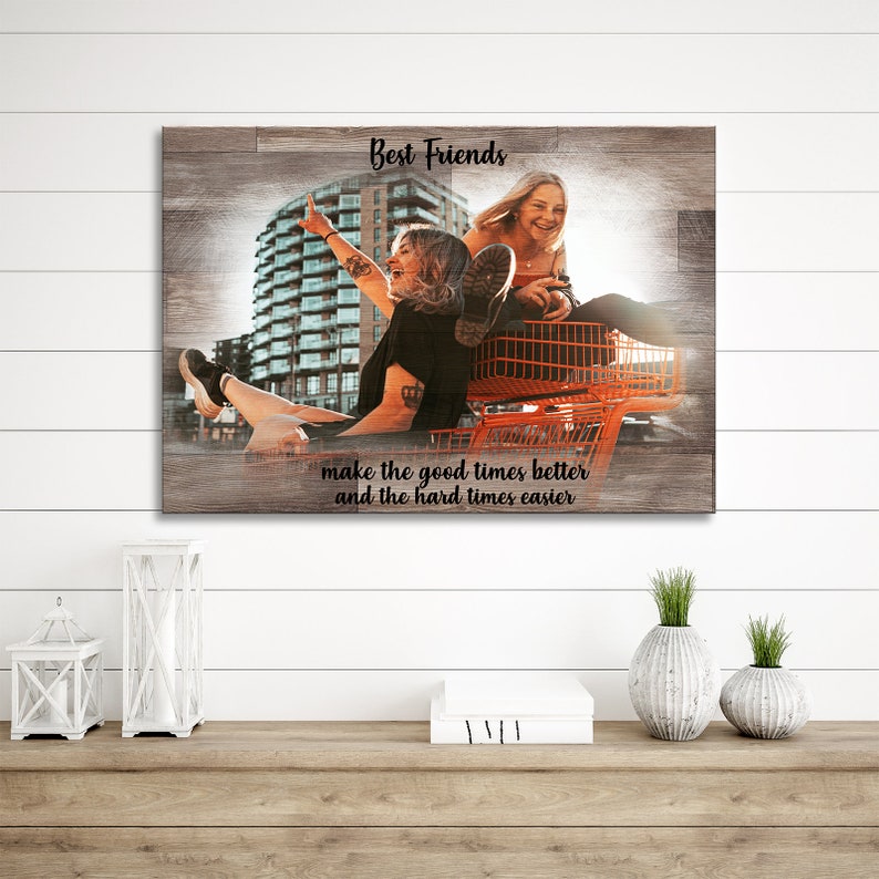 May include: Two friends are riding in a shopping cart in front of a city building. The image has a wood grain background and the text "Best Friends make the good times better and the hard times easier".