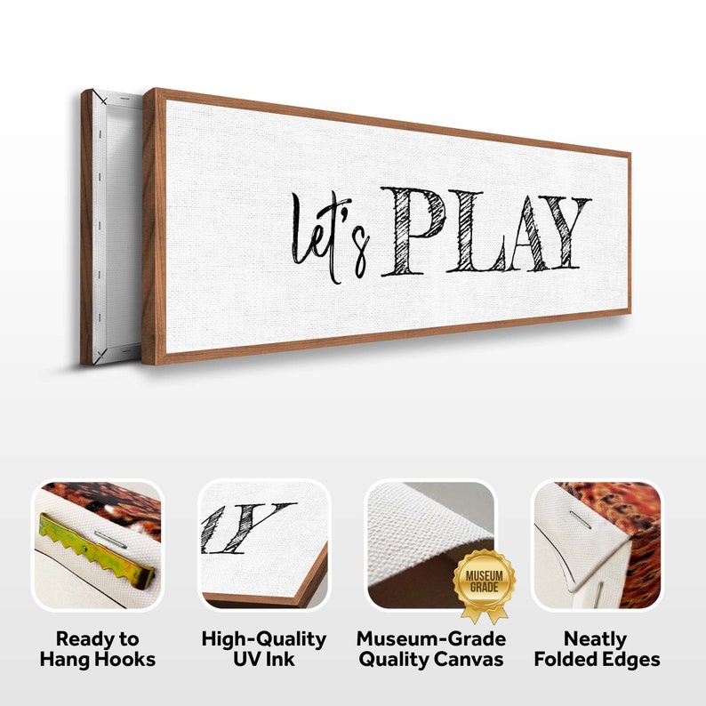 May include: A white canvas print with a wood frame featuring the text "Let's Play" in black script font. The print has sawtooth hangers on the back for easy hanging and comes with neatly folded edges.