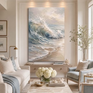 May include: A large vertical oil painting depicting a crashing ocean wave in shades of blue, white, and beige. The textured brushstrokes capture the movement of water breaking onto a sandy shore, creating a dynamic seascape scene.